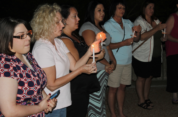 Faculty, staff, students and family members of Mary Herzog participate in a candlelit vigil at Meramec Sept. 8. PHOTO | LIVIE HALL