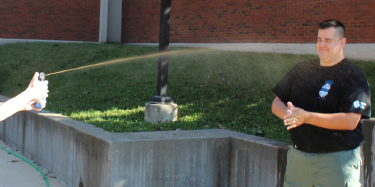 Meramec criminology student Kaylee Matthews sprays Professor Michael Hepner with pepper spray Oct. 3.  PHOTO | SABREE BLACKMON