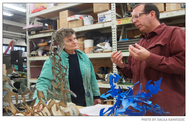 Joe Chesla instructs student, Mary Anne Nye, on what steps to take next with her sculpture.