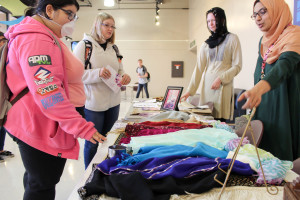 Sophomores Anna Theresa and Sadia Ali (right) offer headscarves to students for Hijab Day on March 28. The event, which encouraged students to try on headscarves and reflect on the experience, was designed by Meramec's Muslim Student Association to fight the stereotype that Muslim women are oppressed.