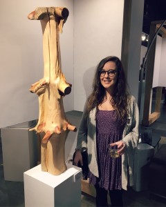 Lacey Call stands next to her sculpture, "Pine", a repurposed tree stump smoothed with an angle grinder tool. "Pine" was one of 42 pieces selected for the St. Louis Varsity Art show and was on display for most of March at the Regional Arts Commission.