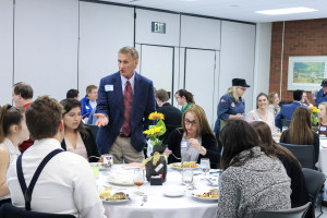 Professor Mark Tulley explains how to properly eat finger foods at the annual Etiquette Luncheon on March 28.